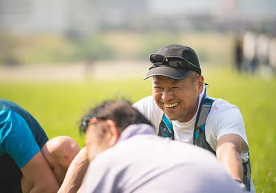Group of men sitting in field laughing