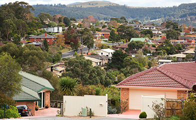 Phone of many houses and mountain in distance